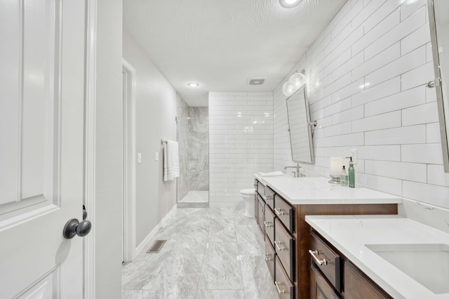 1251 S Rosemoor Dr, Nixa, MO 65714 - bathroom with vanity, tiled shower, tile walls, marble finish floors, and recessed lighting