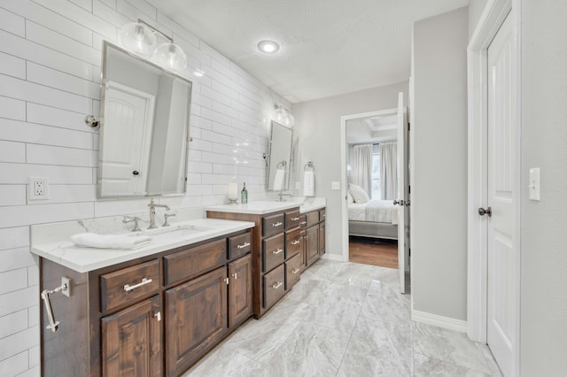 1251 S Rosemoor Dr, Nixa, MO 65714 - ensuite bathroom with double vanity and marble finish floors