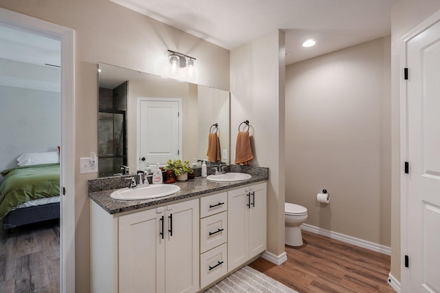 816 S Rockburn Ct, Nixa, MO 65714 - ensuite bathroom with double vanity, a stall shower, and wood finished floors