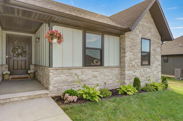 816 S Rockburn Ct, Nixa, MO 65714 - doorway to property with stone siding, roof with shingles, a yard, and board and batten siding