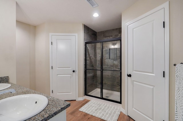 816 S Rockburn Ct, Nixa, MO 65714 - full bath with double vanity, a shower stall, wood finished floors, and recessed lighting