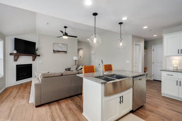 816 S Rockburn Ct, Nixa, MO 65714 - kitchen with stainless steel dishwasher, light wood-style flooring, open floor plan, vaulted ceiling, and recessed lighting