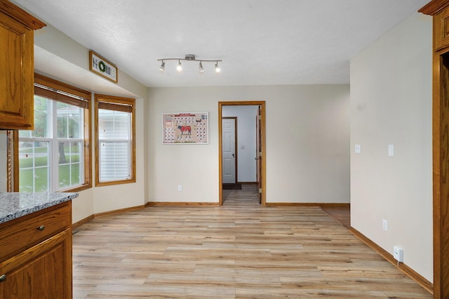 431 S Yellowwood Dr, Springfield, MO 65809 - unfurnished dining area featuring baseboards and light wood finished floors