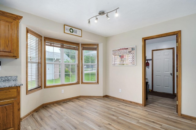 431 S Yellowwood Dr, Springfield, MO 65809 - unfurnished dining area with light wood-type flooring and baseboards