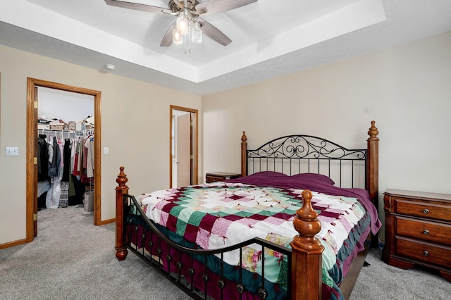 431 S Yellowwood Dr, Springfield, MO 65809 - bedroom with carpet flooring, a spacious closet, a raised ceiling, and a ceiling fan