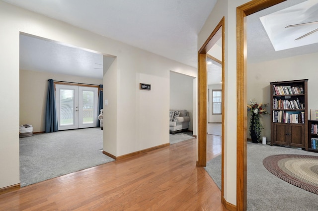 431 S Yellowwood Dr, Springfield, MO 65809 - corridor featuring a skylight, light wood-style floors, light carpet, and french doors