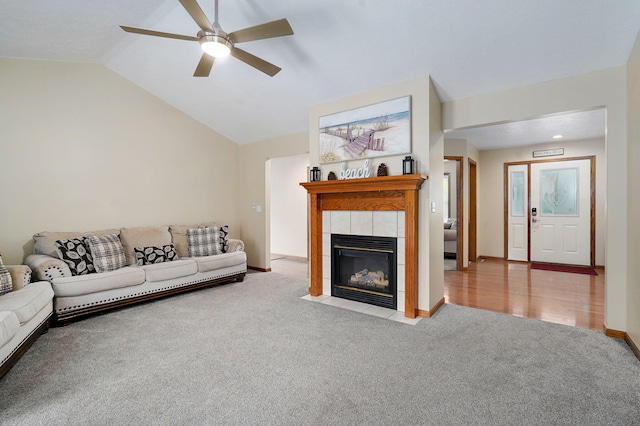 431 S Yellowwood Dr, Springfield, MO 65809 - living room with carpet, a ceiling fan, a tiled fireplace, and vaulted ceiling