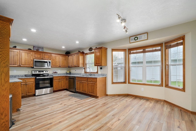 431 S Yellowwood Dr, Springfield, MO 65809 - kitchen featuring stainless steel appliances, brown cabinets, light wood-style flooring, recessed lighting, and light stone counters