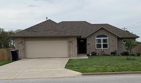 100 Hawthorn Ave, Rogersville, MO 65742 - ranch-style home with a garage, concrete driveway, brick siding, and roof with shingles