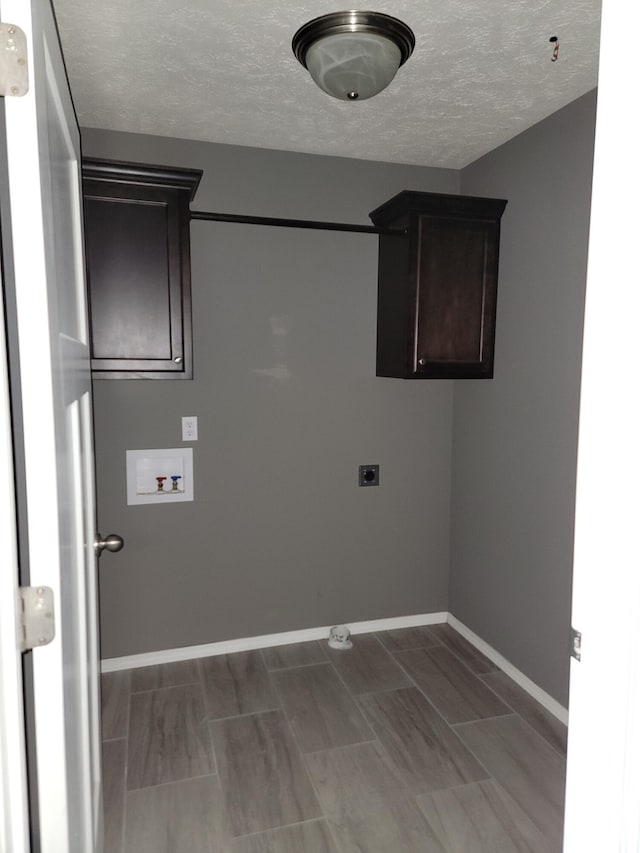 100 Hawthorn Ave, Rogersville, MO 65742 - laundry area with hookup for a washing machine, electric dryer hookup, cabinet space, and a textured ceiling
