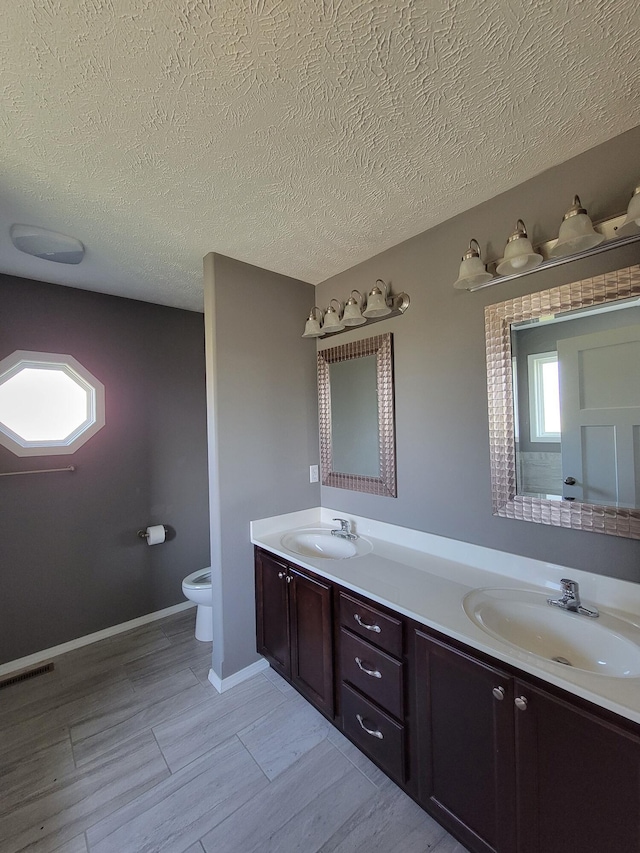 100 Hawthorn Ave, Rogersville, MO 65742 - bathroom with double vanity, a textured ceiling, and wood finished floors