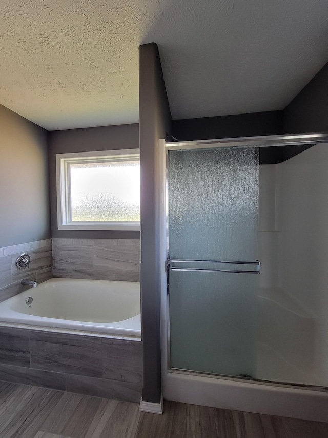 100 Hawthorn Ave, Rogersville, MO 65742 - full bathroom with a shower stall, a bath, wood finished floors, and a textured ceiling