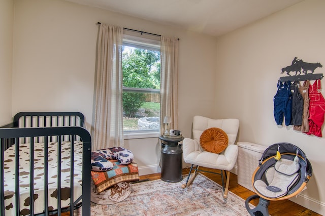 135 Roark Ave, Branson, MO 65616 - bedroom featuring wood finished floors and a nursery area