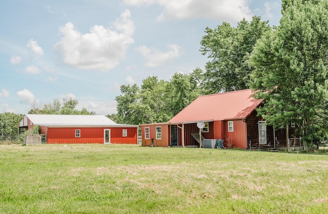 22783 Lawrence Unit 1210, Aurora, MO 65605 - rear view of property featuring a yard, a metal roof, and an outbuilding