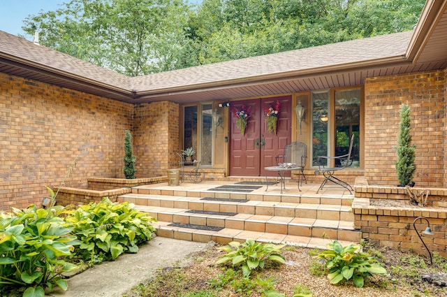 667 S Broadview Dr, Springfield, MO 65809 - doorway to property featuring covered porch, roof with shingles, and brick siding