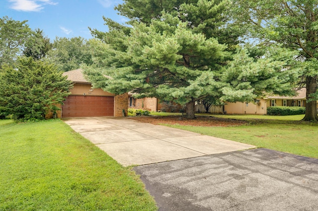 667 S Broadview Dr, Springfield, MO 65809 - view of front facade featuring a front yard, driveway, an attached garage, and brick siding