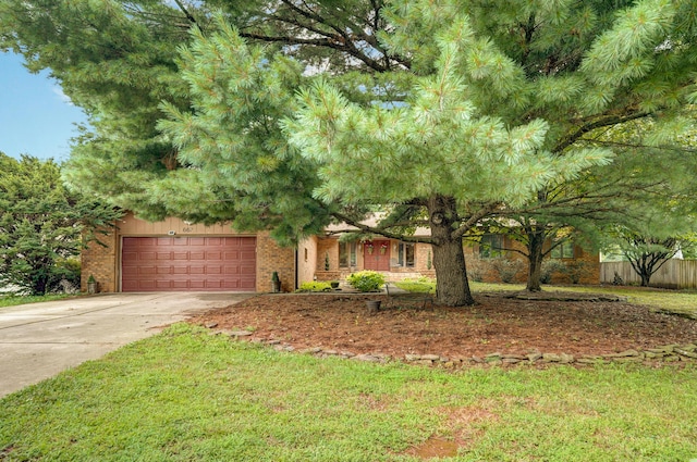 667 S Broadview Dr, Springfield, MO 65809 - obstructed view of property featuring driveway, brick siding, and a garage