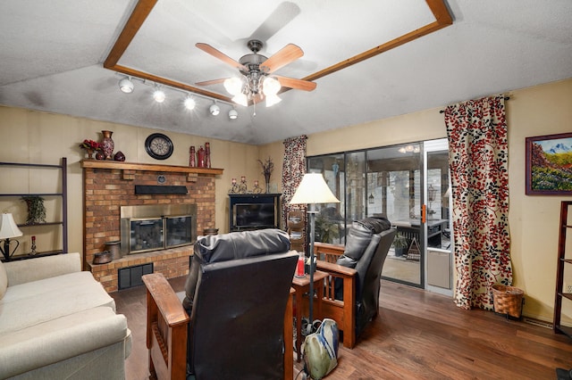 667 S Broadview Dr, Springfield, MO 65809 - living area featuring ceiling fan, wood finished floors, a textured ceiling, and a brick fireplace