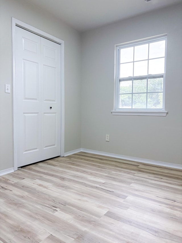 905 NW Blvd, Neosho, MO 64850 - unfurnished bedroom featuring light wood-style floors and a closet