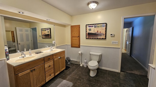 5143 State Highway 95, Drury, MO 65638 - bathroom with a wainscoted wall, double vanity, a baseboard heating unit, and tile patterned flooring