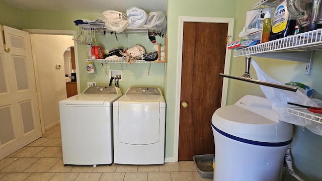 5143 State Highway 95, Drury, MO 65638 - laundry room with washer and dryer, arched walkways, and light tile patterned floors