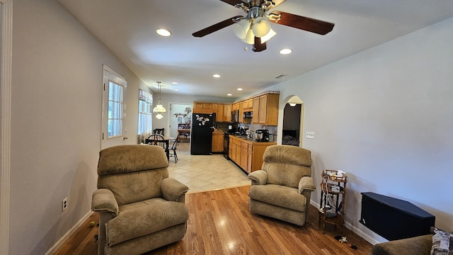 5143 State Highway 95, Drury, MO 65638 - living area featuring arched walkways, a ceiling fan, recessed lighting, and light wood-type flooring