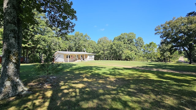 5143 State Highway 95, Drury, MO 65638 - view of grassy yard featuring a wooded view and covered porch