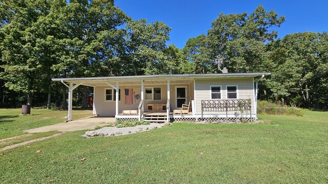 5143 State Highway 95, Drury, MO 65638 - view of front of property with covered porch, a front lawn, an attached carport, and concrete driveway