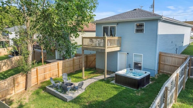 310 W College St, Branson, MO 65616 - rear view of property featuring a balcony, a fenced backyard, a hot tub, and a shingled roof