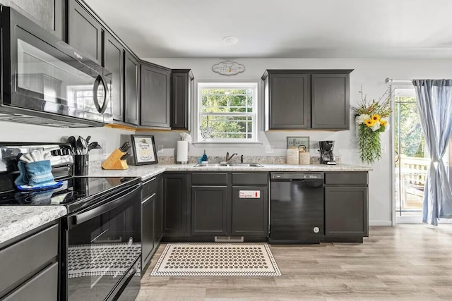 310 W College St, Branson, MO 65616 - kitchen with black appliances, light wood-style flooring, and light stone countertops