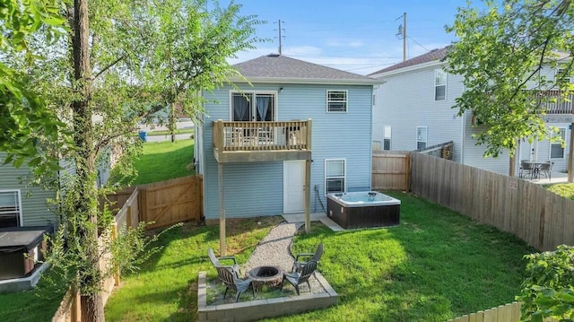 310 W College St, Branson, MO 65616 - rear view of house with an outdoor fire pit, a fenced backyard, a balcony, and a shingled roof