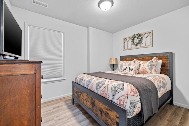 310 W College St, Branson, MO 65616 - bedroom with wood finished floors and baseboards