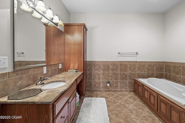 318 Fox Fire Ct, Joplin, MO 64801 - full bath featuring tile walls, vanity, a bath, tile patterned flooring, and wainscoting