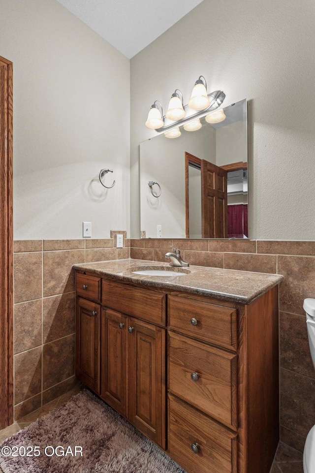 318 Fox Fire Ct, Joplin, MO 64801 - bathroom with tile walls, vanity, and wainscoting
