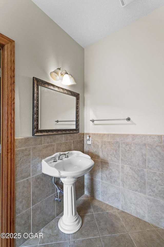 318 Fox Fire Ct, Joplin, MO 64801 - bathroom with tile walls, a wainscoted wall, and tile patterned floors