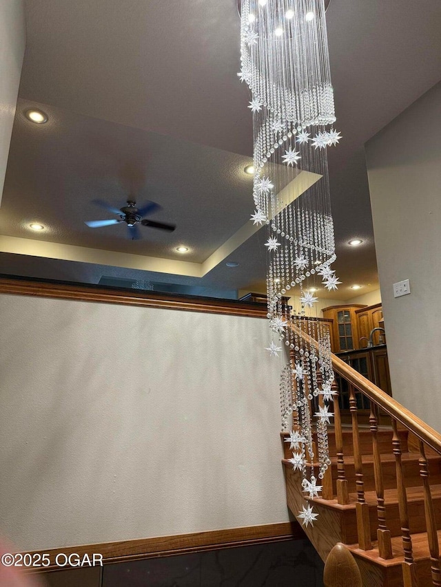 318 Fox Fire Ct, Joplin, MO 64801 - stairs with recessed lighting, a chandelier, and a ceiling fan