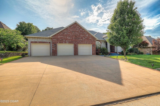 318 Fox Fire Ct, Joplin, MO 64801 - view of front of home with brick siding, a front lawn, a garage, and roof with shingles