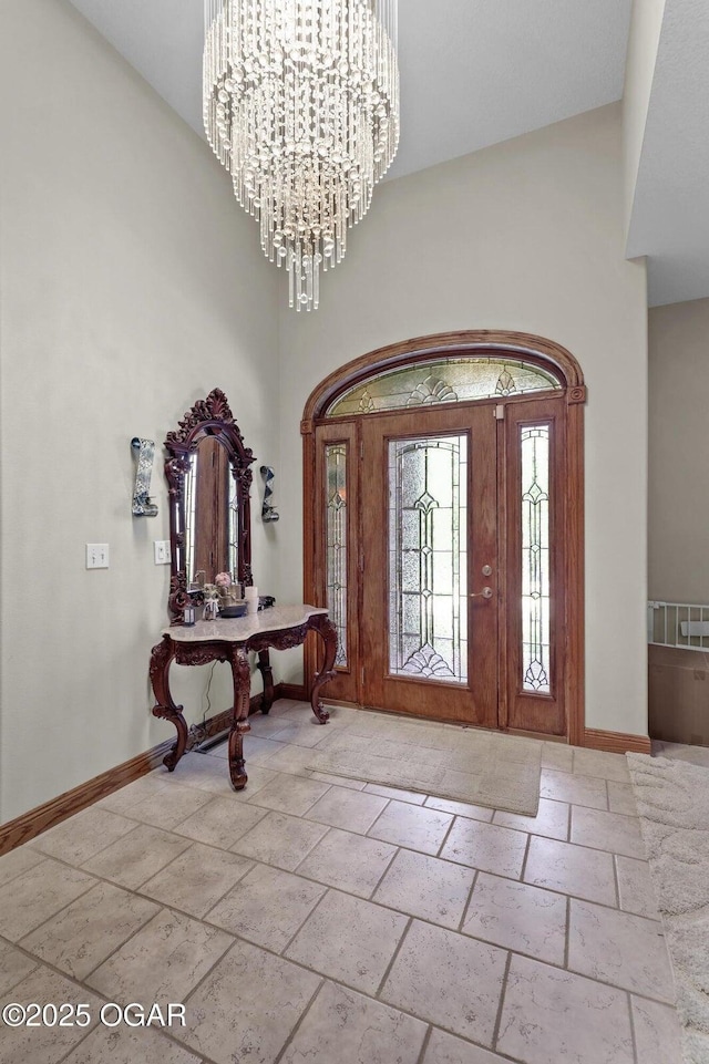 318 Fox Fire Ct, Joplin, MO 64801 - entryway featuring a high ceiling, stone tile flooring, and a chandelier