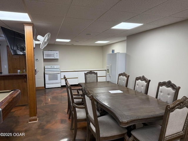 318 Fox Fire Ct, Joplin, MO 64801 - dining room featuring finished concrete flooring and a paneled ceiling