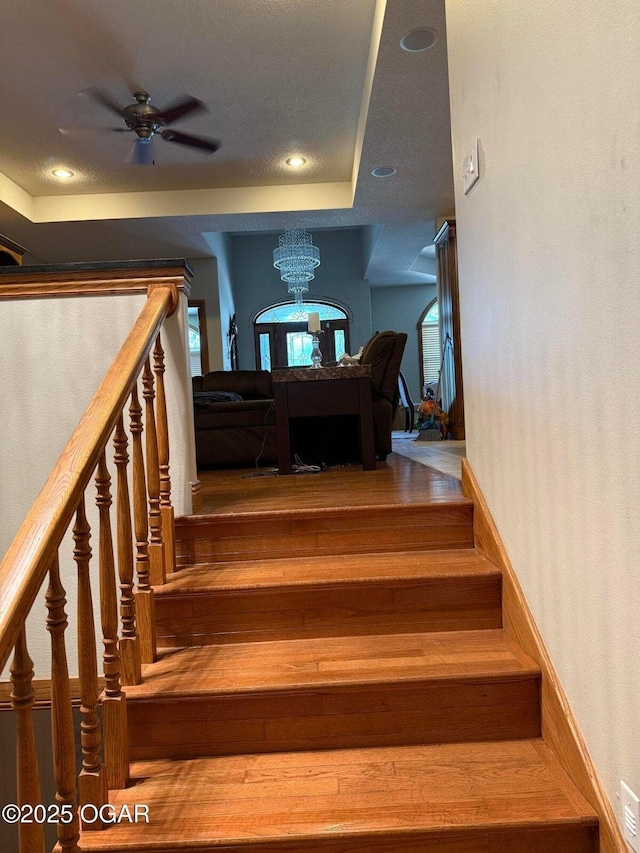318 Fox Fire Ct, Joplin, MO 64801 - stairs featuring ceiling fan, a chandelier, and recessed lighting