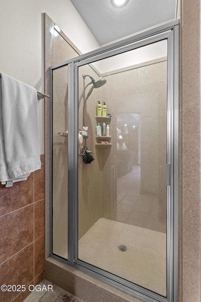 318 Fox Fire Ct, Joplin, MO 64801 - bathroom featuring a shower stall and a textured ceiling