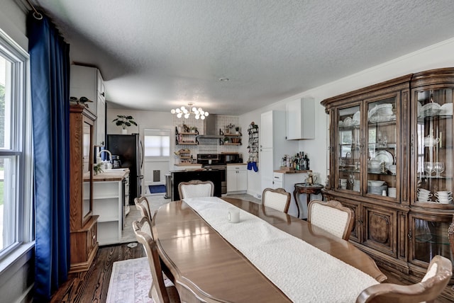 1508 S Moffet Ave, Joplin, MO 64804 - dining area featuring a textured ceiling, a chandelier, and dark wood finished floors