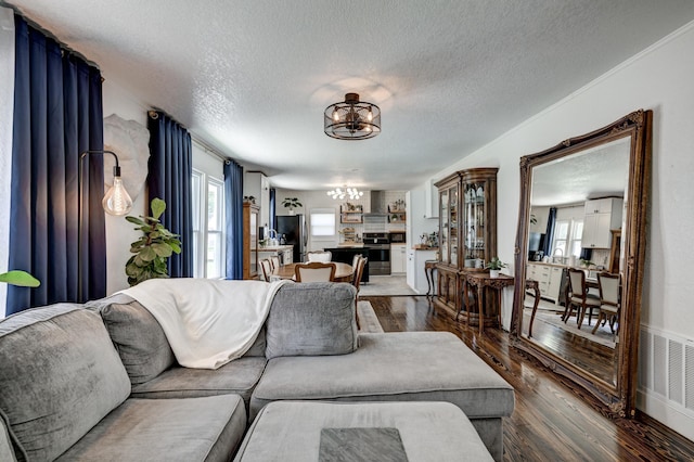 1508 S Moffet Ave, Joplin, MO 64804 - living area with a chandelier, dark wood-type flooring, and a textured ceiling