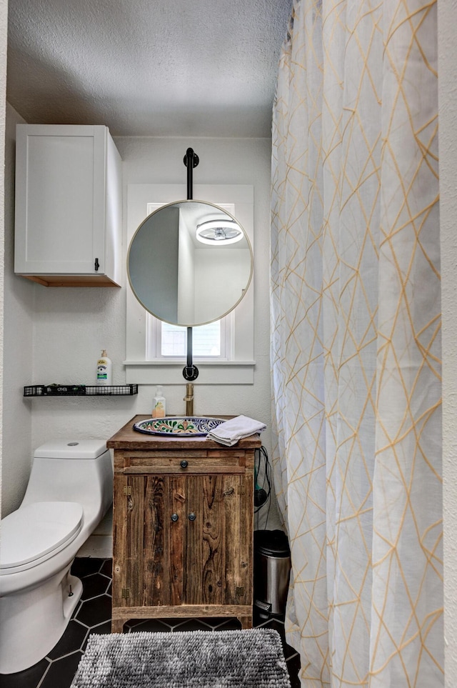 1508 S Moffet Ave, Joplin, MO 64804 - bathroom with a textured ceiling, vanity, and tile patterned flooring