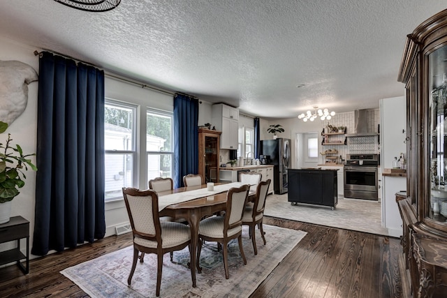 1508 S Moffet Ave, Joplin, MO 64804 - dining area featuring a chandelier, light wood-type flooring, and a textured ceiling