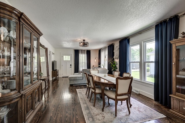 1508 S Moffet Ave, Joplin, MO 64804 - dining space with healthy amount of natural light, a textured ceiling, and dark wood-style floors