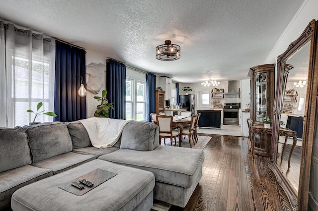 1508 S Moffet Ave, Joplin, MO 64804 - living area with a textured ceiling, a chandelier, and dark wood-type flooring