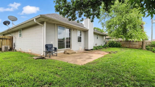 205 W Hunter Dr, Nixa, MO 65714 - rear view of property with a chimney, a fenced backyard, a patio area, and a shingled roof