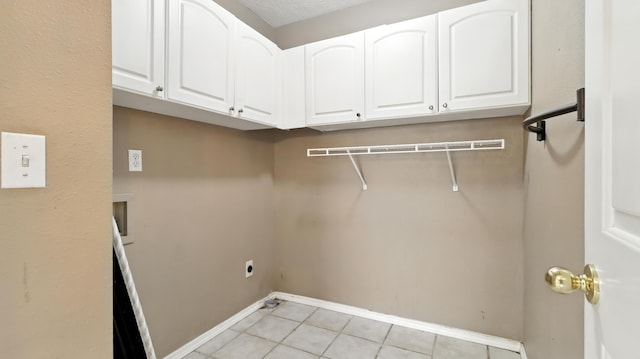 205 W Hunter Dr, Nixa, MO 65714 - washroom with cabinet space, hookup for an electric dryer, and light tile patterned floors