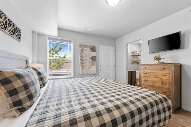302 W College St, Branson, MO 65616 - bedroom featuring wood finished floors and ensuite bathroom